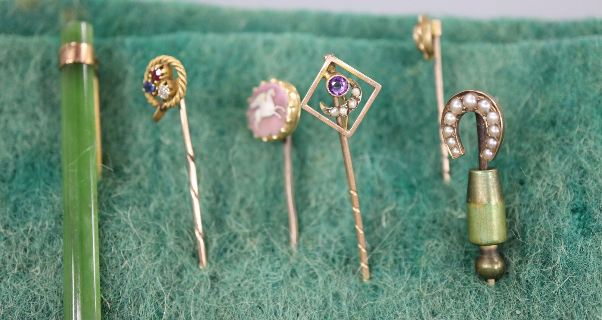 Five various stick pins and a jade bar brooch